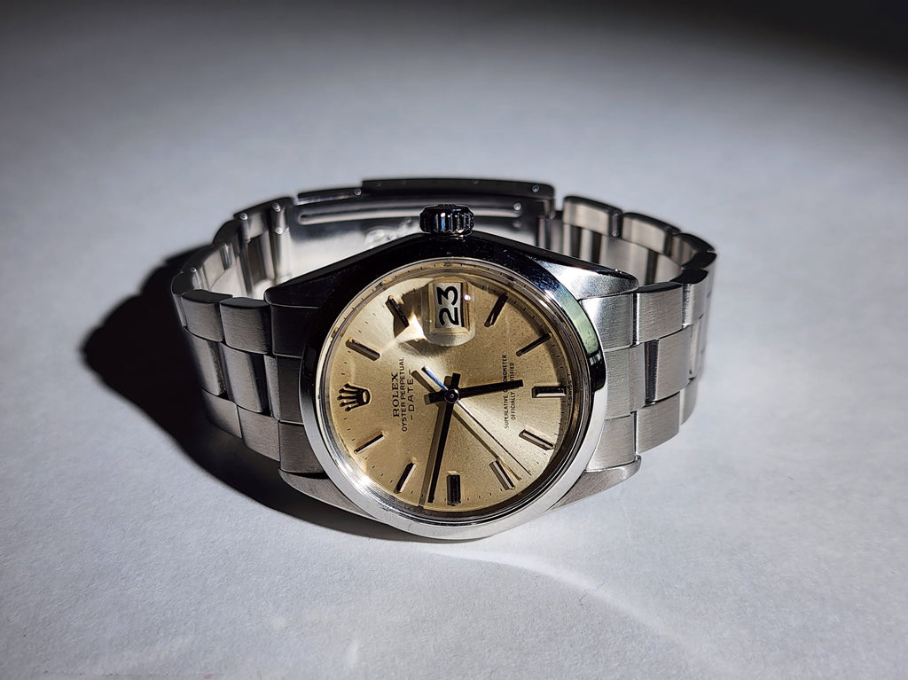 Vintage Rolex Date with original champagne dial and an original stainless steel band.